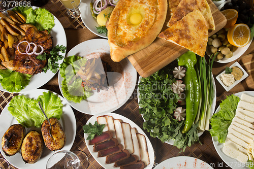 Image of table with normal food, steaks and potatoes. 