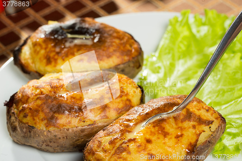 Image of baked potatoes whole in their skins 