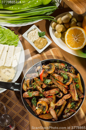 Image of table with normal food, steaks and potatoes. 