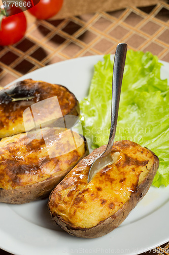 Image of baked potatoes whole in their skins 