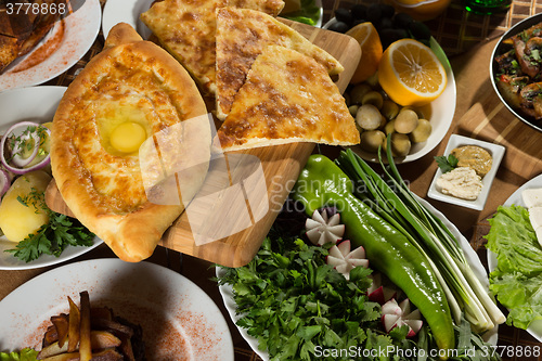 Image of table with normal food, steaks and potatoes. 