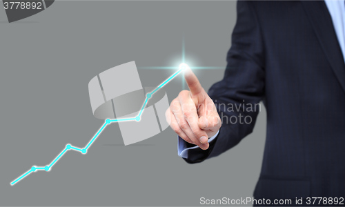 Image of Businessman Touching a Graph Indicating Growth