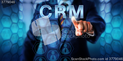 Image of Manager Pushing CRM Onscreen\r