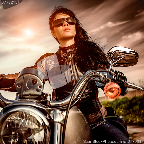 Image of Biker girl on a motorcycle