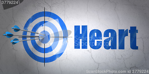 Image of Health concept: target and Heart on wall background