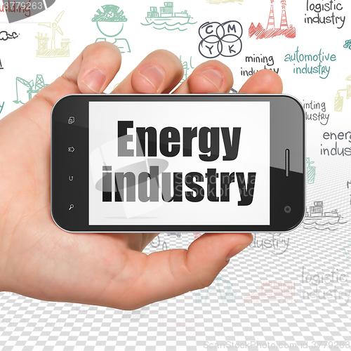 Image of Manufacuring concept: Hand Holding Smartphone with Energy Industry on display