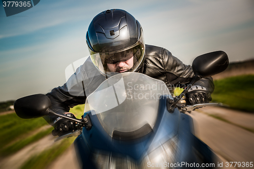 Image of Biker racing on the road