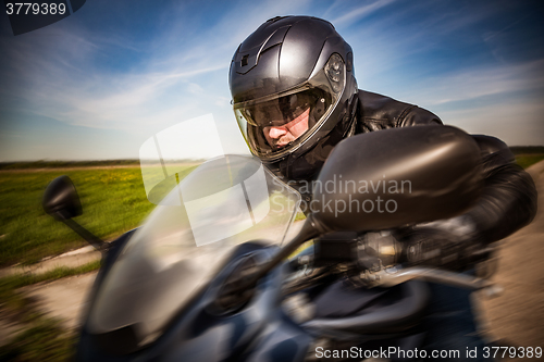 Image of Biker racing on the road