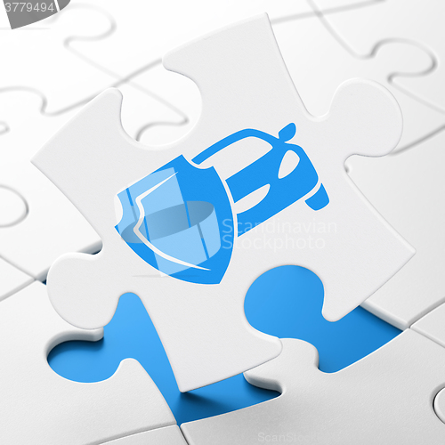 Image of Insurance concept: Car And Shield on puzzle background