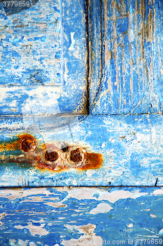 Image of   paint in blue wood door rusty nail