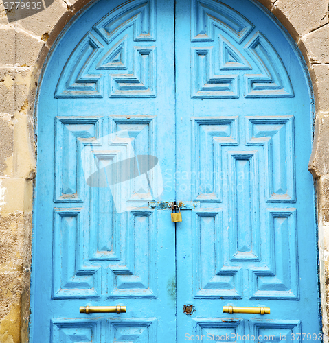 Image of antique door in morocco africa blue wood and metal rusty