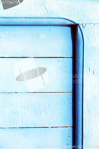 Image of nail stripped   in the blue wood door  rusty 