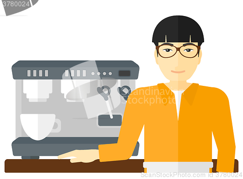 Image of Barista standing near coffee maker.