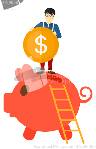 Image of Man putting coin in piggy bank.