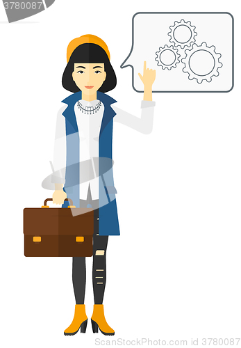 Image of Business woman pointing at cogwheels.