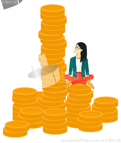 Image of Business woman sitting on gold.