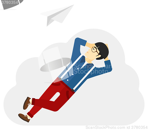 Image of Businessman relaxing on cloud.