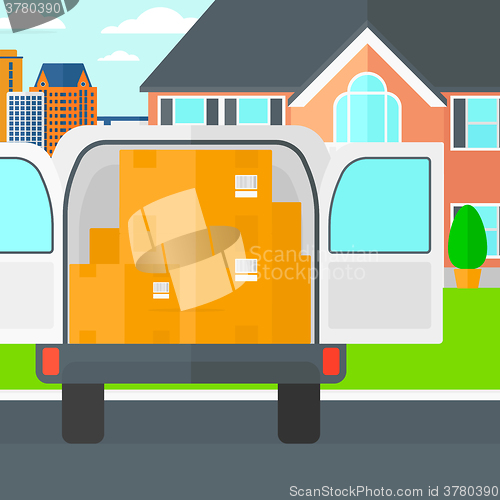 Image of Background of delivery truck with an open door and cardboard boxes in front of house.