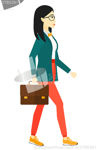 Image of Business woman walking with briefcase. 