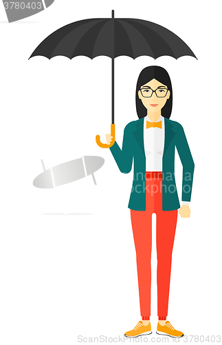 Image of Business woman standing with umbrella.