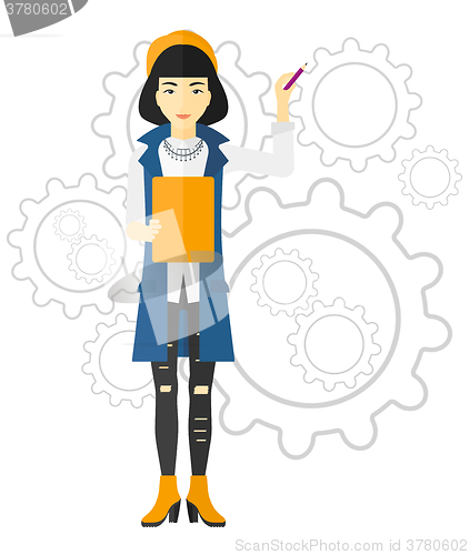 Image of Woman standing on gears background.