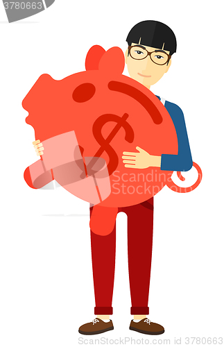 Image of Man carrying piggy bank.