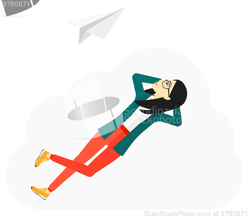 Image of Business woman relaxing on cloud.