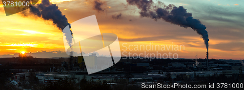 Image of Sunrise silhouette of smoking factory