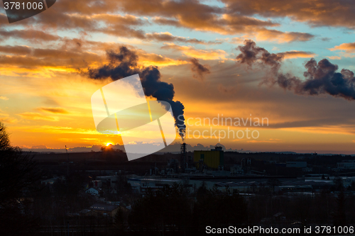 Image of Sunrise silhouette of smoking factory