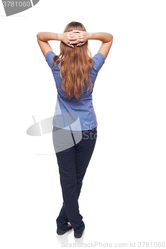 Image of Back view of a woman standing with hands over head