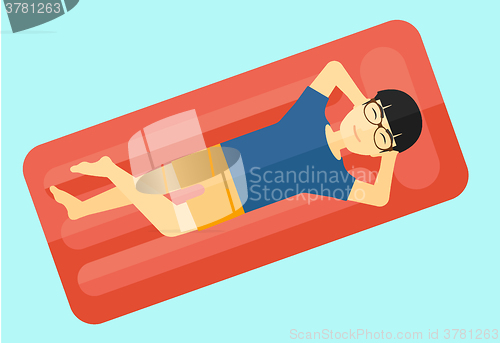 Image of Man relaxing in swimming pool.