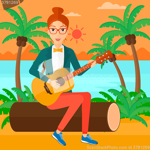 Image of Woman playing guitar.