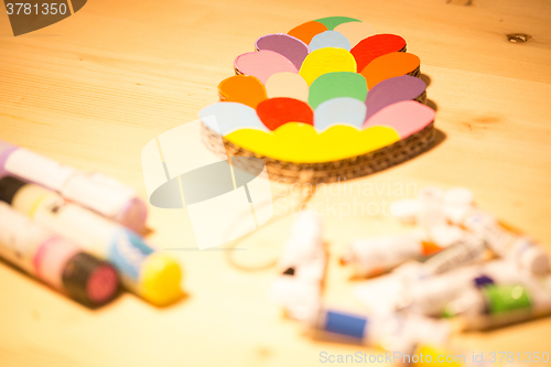 Image of Colorful toys made of cardboard on a wooden table.