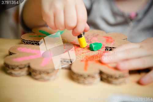 Image of Little female baby painting with colorful paints