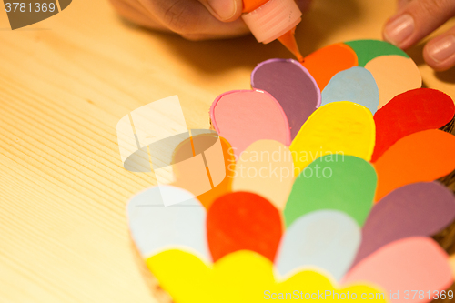 Image of Colorful toys made of cardboard on a wooden table.