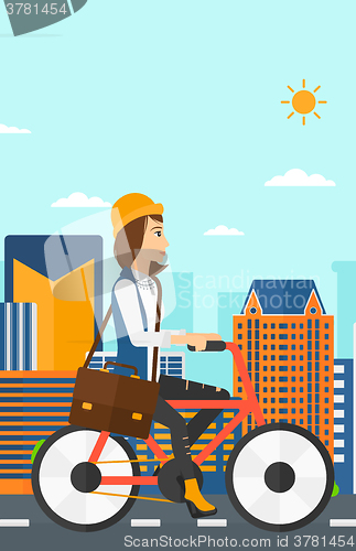 Image of Woman cycling to work.