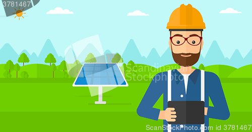 Image of Man holding tablet computer.