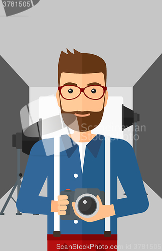 Image of Smiling photographer holding camera.