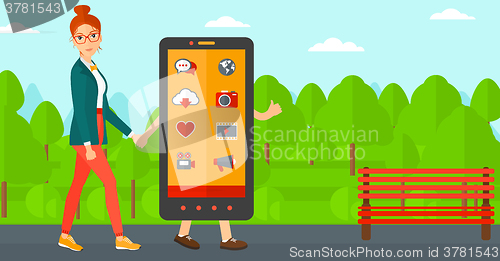 Image of Woman walking with smartphone.