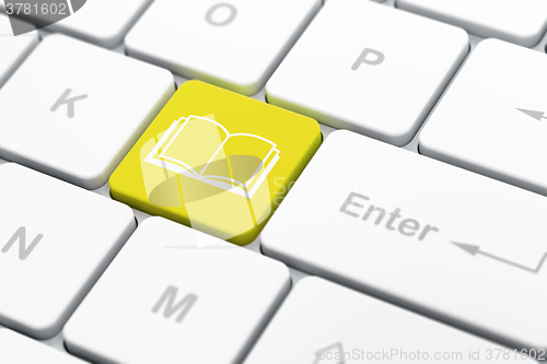 Image of Education concept: Book on computer keyboard background