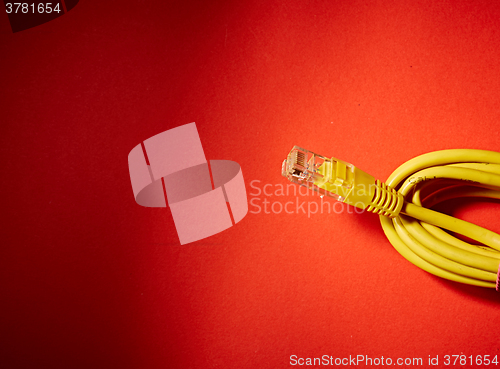 Image of yellow network cable on red background