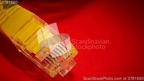 Image of yellow network cable on red background
