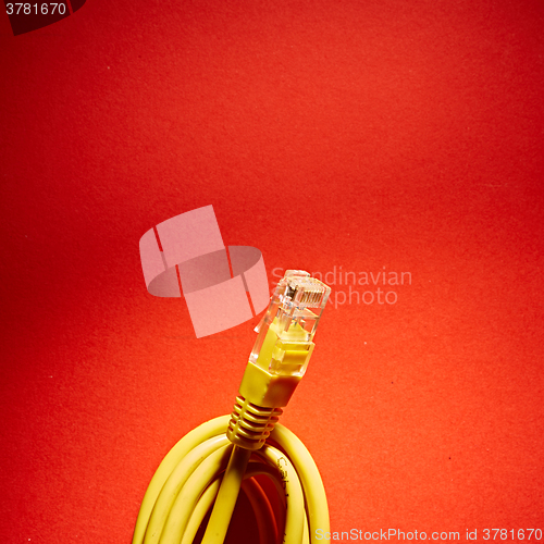 Image of yellow network cable on red background