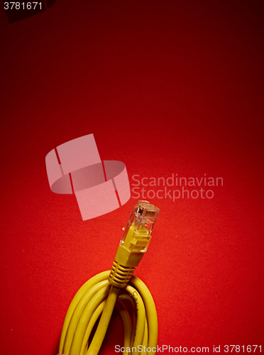 Image of yellow network cable on red background