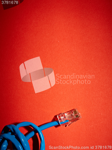 Image of Blue network cable on red background
