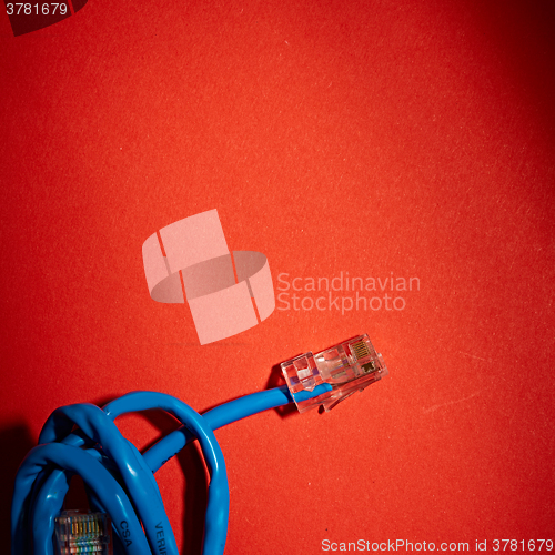 Image of Blue network cable on red background
