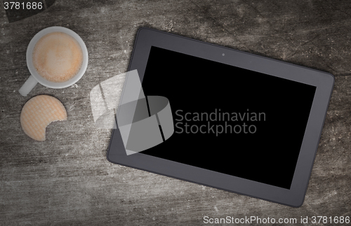 Image of Tablet touch computer gadget on wooden table