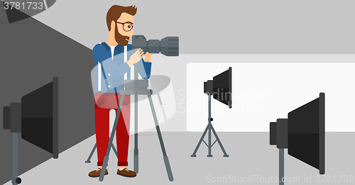 Image of Photographer working with camera on a tripod.