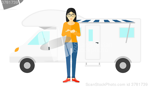 Image of Woman standing in front of motor home.