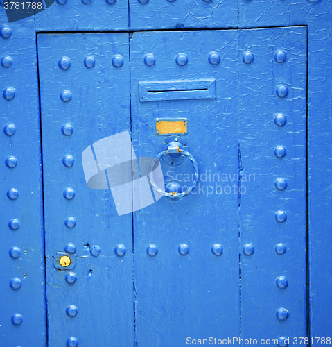 Image of antique door in morocco africa blue wood and metal rusty